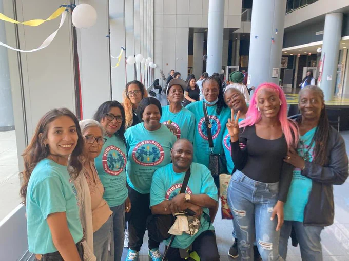 A group picture of 11 Black and Latinx parent leaders posing for a group picture