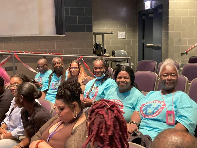 Six parent leaders sitting during the board meeting