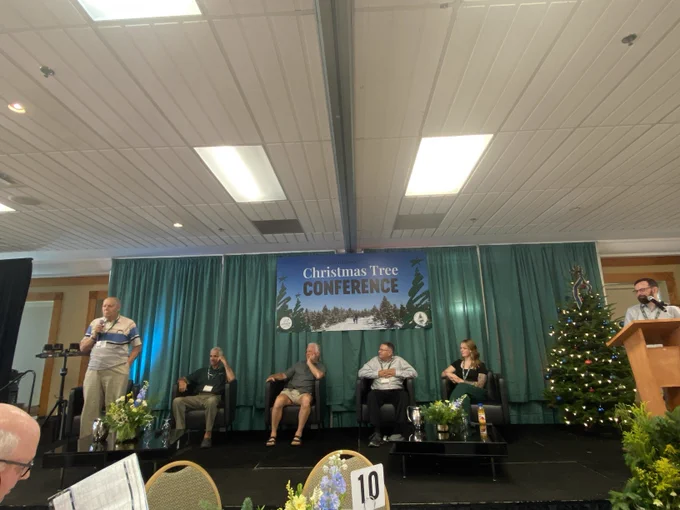 Six people on a stage participating in a panel discussion.
