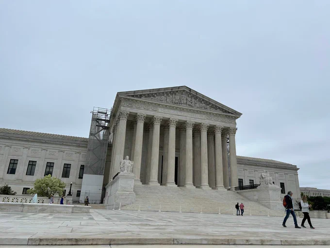 The US Supreme Court's grey columns in front of a grey sky.