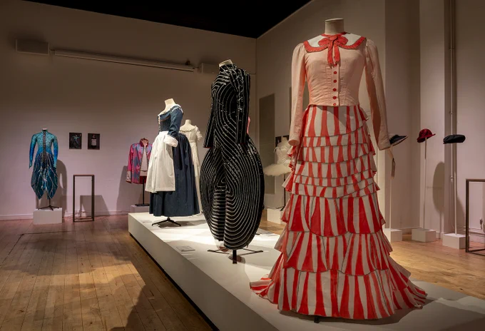 Costumes on display in an exhibition space