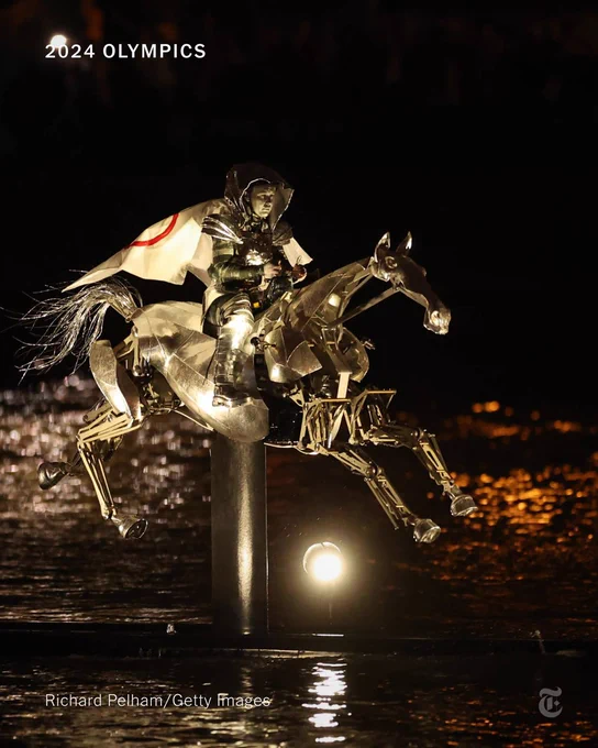 The Horsewoman, wearing the Flag of the International Olympic Committee (IOC), is seen on a Metal Horse on the River Seine. Photo credit: Richard Pelham/Getty Images
