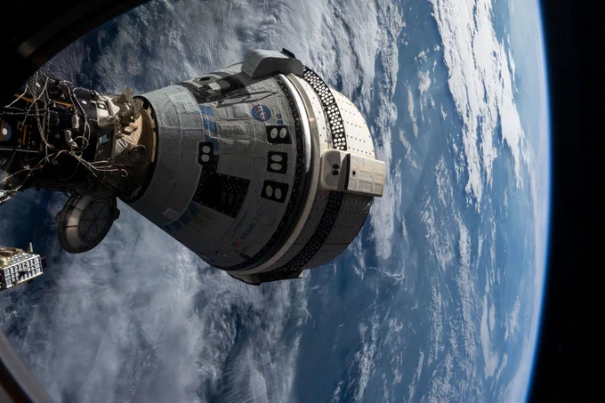 Boeing's Starliner spacecraft that launched NASA's Crew Flight Test astronauts Butch Wilmore and Suni Williams to the International Space Station is pictured docked to the Harmony module's forward port. This view is from a window on the SpaceX Dragon Endeavour spacecraft docked to the port adjacent to the Starliner. (Credit: NASA)
