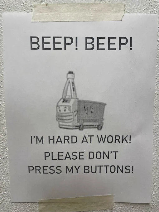Sign says Beep Beep Im Hard at work don’t push my buttons!