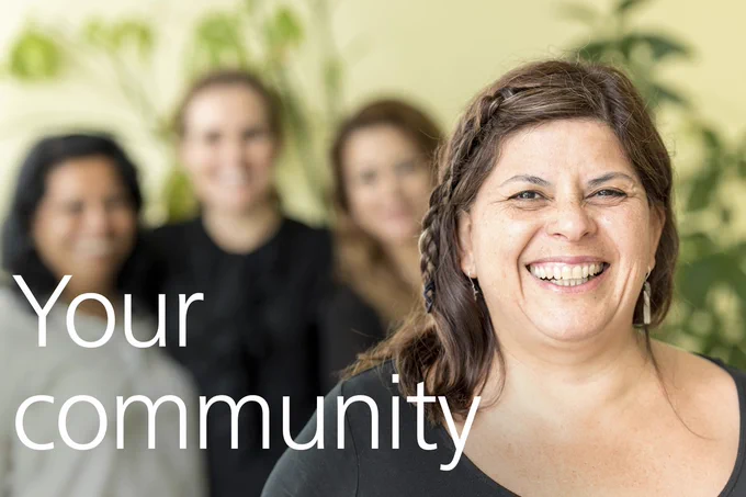 A smiling woman with text overlaid that reads " Your Community"