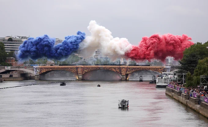 Photography of the pyrotechnics at the Paris 2024 Olympics Opening Ceremony, captured on a bridge over the Seine River.