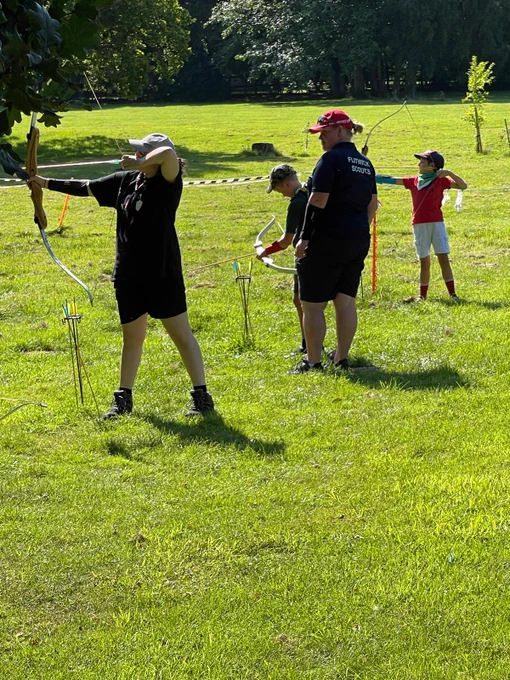 Cubs aiming archery bows