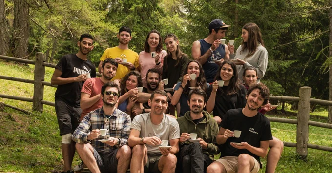 Belka's team drinking coffee in the woods.