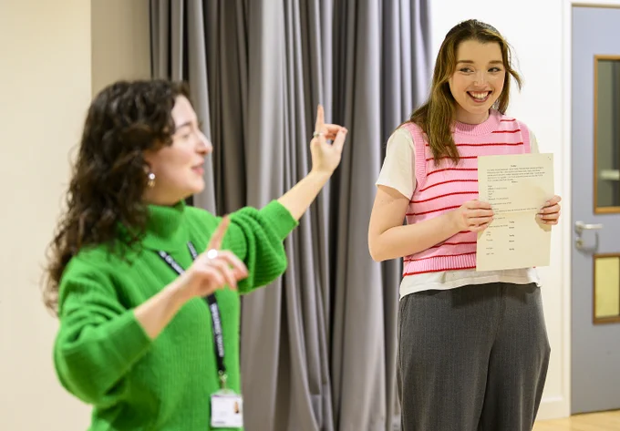 A student and tutor rehearse a scene in a studio space