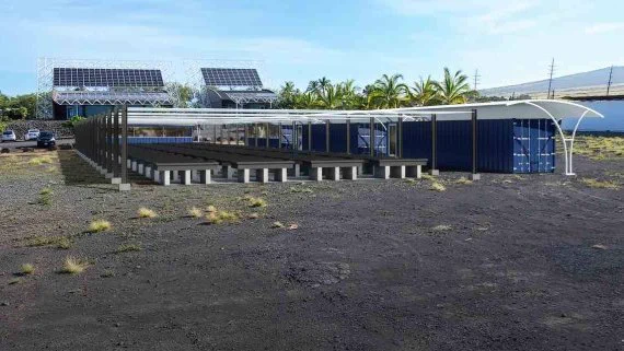 An open air structure with rows of tanks in an open parking lot.