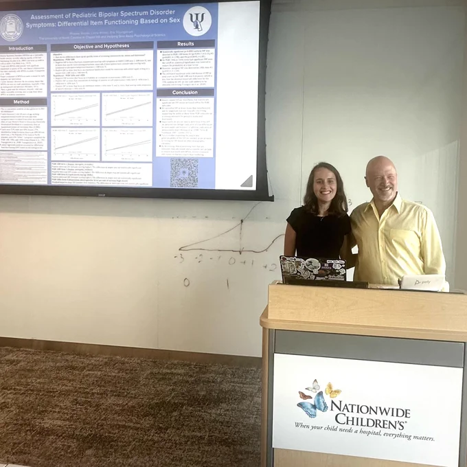 UNC graduate Phoebe Rodda presenting a research poster with Dr. Eric Youngstrom.