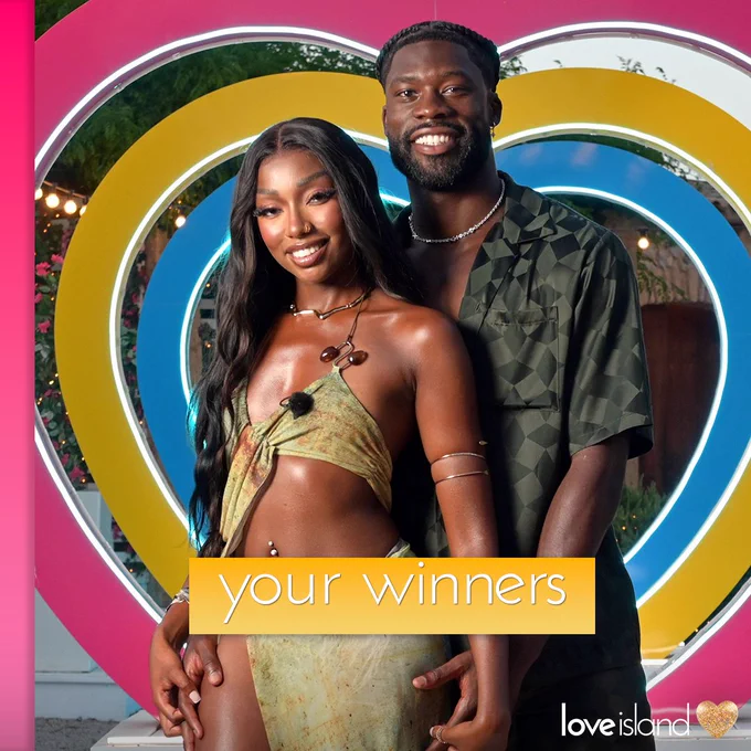 An image of Mimii and Josh in front of the hearts with the text ‘Your Winners’ on it