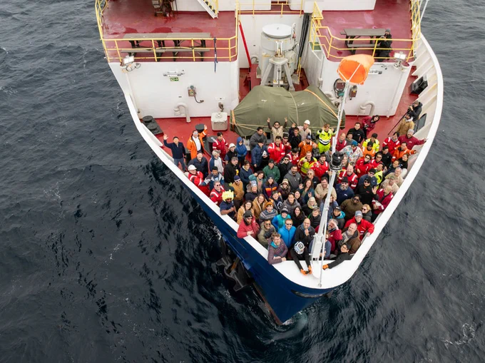 A group photo of Expedition 403 participants on the bow taken by drone. (Credit: Chris Lyons & IODP) 