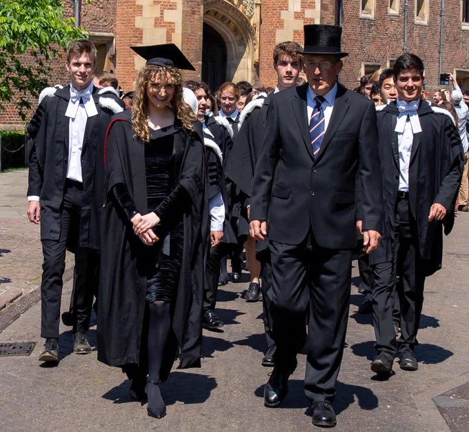 A Research Fellow from St John's College and the Deputy Head Porter lead the congregation of graduands through the Great Gate of St John's College, Cambridge, towards the Senate House for their 2024 graduation.

Credit: Nordin Ćatić