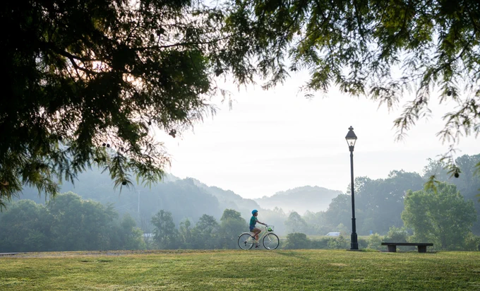 A biker on a path during an early morning in Athens, Ohio.