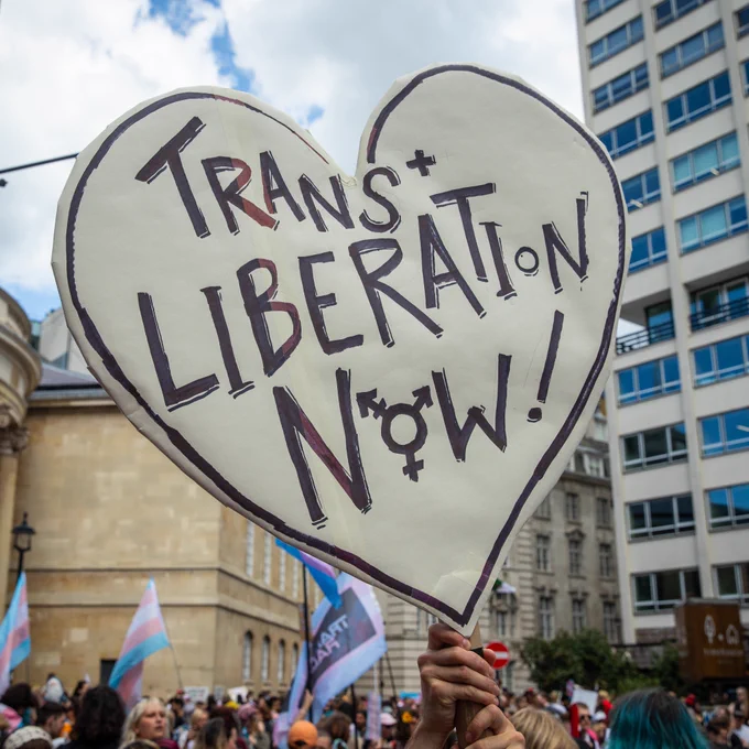 A placard in the shape of a heart that says Trans Liberation Now