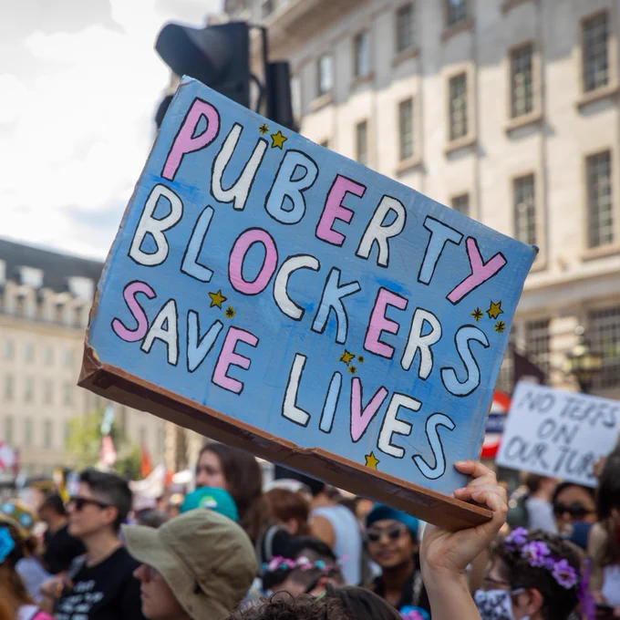 A placard that says puberty blockers save lives