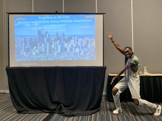 Photo of Sylvana Ross in front of her title slide at the Evolution 2024 conference