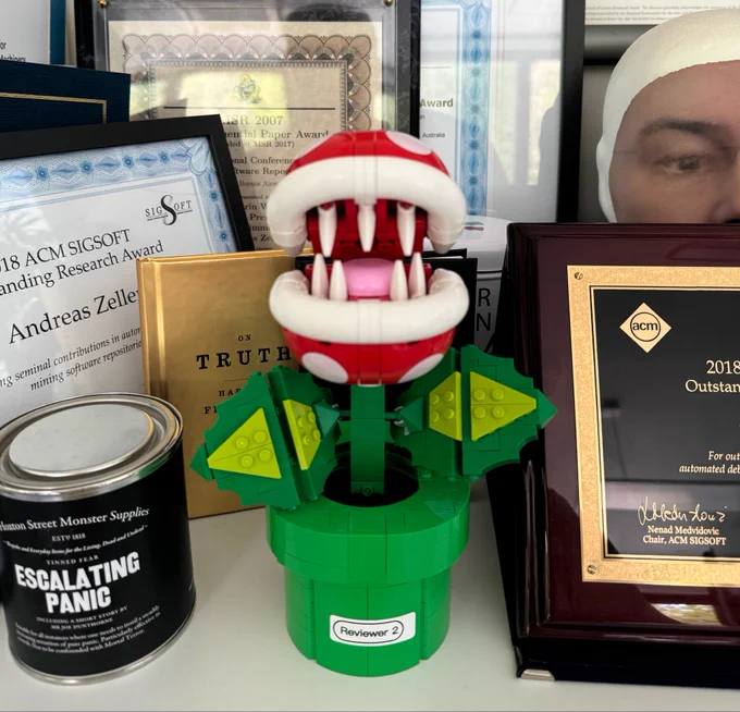 Lego Super Mario model of a piranha plant, with a sticker “Reviewer 2” on the pot