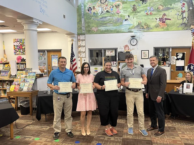 Teachers with recognition certificates