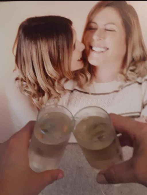 Pic from a photo shoot myself & daughter big smiles hair shoulder length and curled curled 2 glasses of pressco 