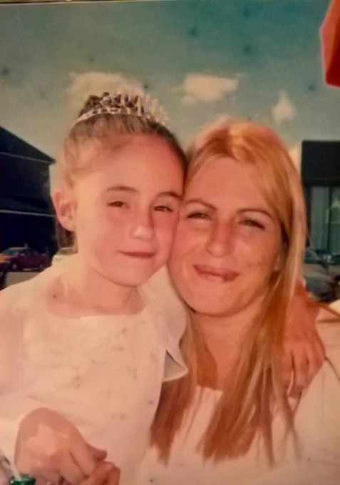 Pic of myself & my daughter aged 7 on her communion day she is dressed in white dark hair all up and tiara on her head I'm blonde in my early 30's