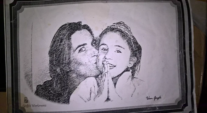 Black & white sketch of me kissing my daughter aged 4 with a tiara on her head holding her hands together in prayer like hold