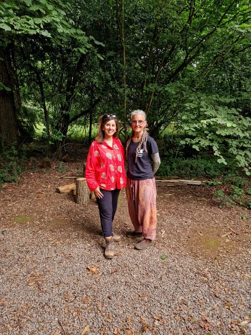 2 women standing in a forest following a grounding meditation. 