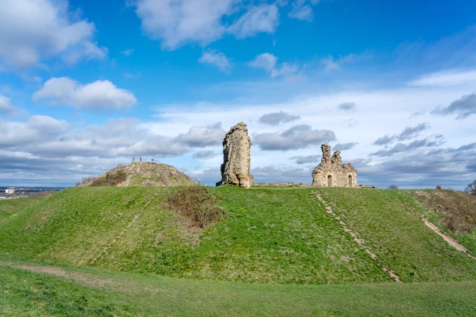 The remains of Sandal Castle atop the grass bailey