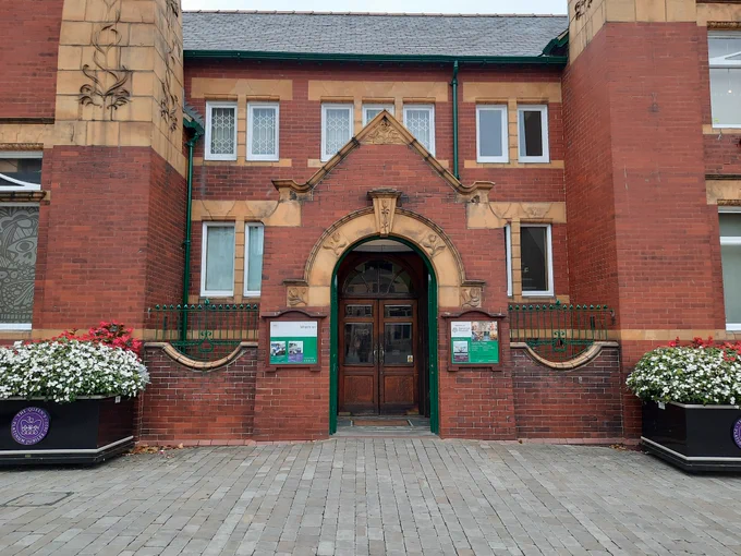  Pontefract Museum, an art nouveau building with arched entrance and planters either side