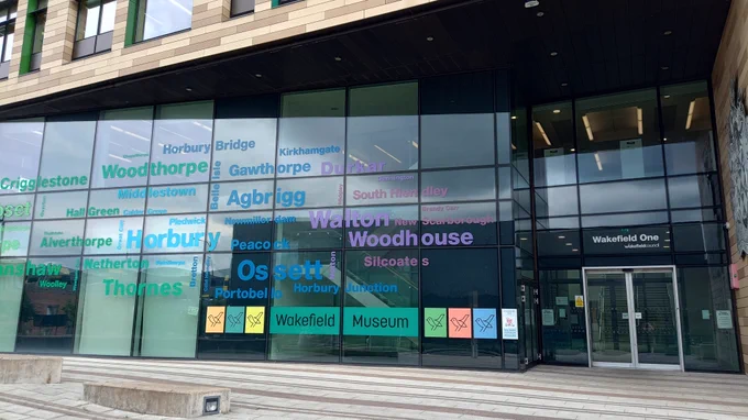 Outside of the Wakefield One building which houses Wakefield Museum. The large windowed area next to the entrance has the names of different places in the Wakefield district on it.