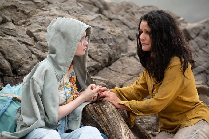 Still from Tuesday showing teenager holding hands with a woman who is looking very sad.