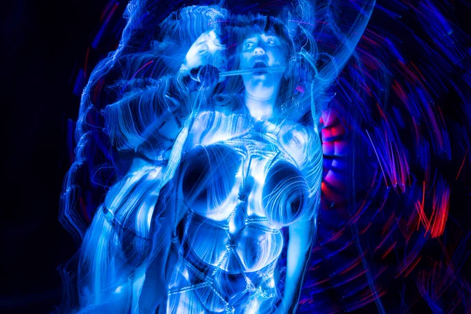 a still from helping hands shows glowing light and bondage