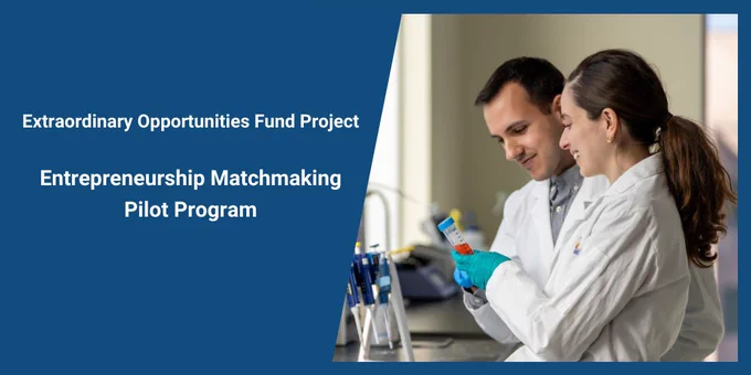 A banner image for “Entrepreneurship Matchmaking Pilot Program” under the “Extraordinary Opportunities Fund Project.” The photo features two researchers in a lab, one wearing a white coat and blue gloves, handling a test tube with a blue cap. They are surrounded by lab equipment, indicating an active research environment.