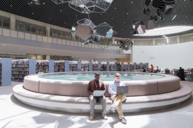 Two NYUAD community members writing in the NYUAD Library, near the Writing Center.