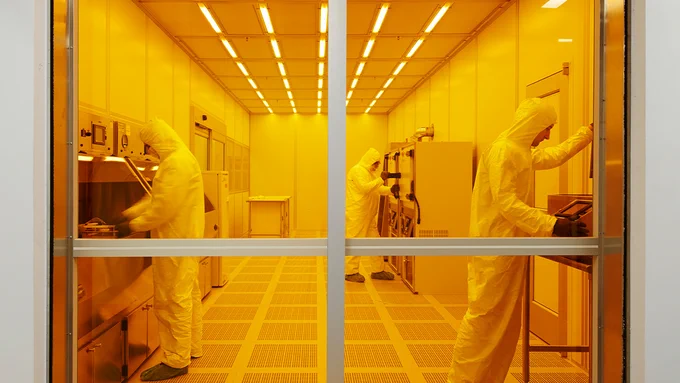A photo of three people working in the CUNY ASRC's Nanofabrication Facility