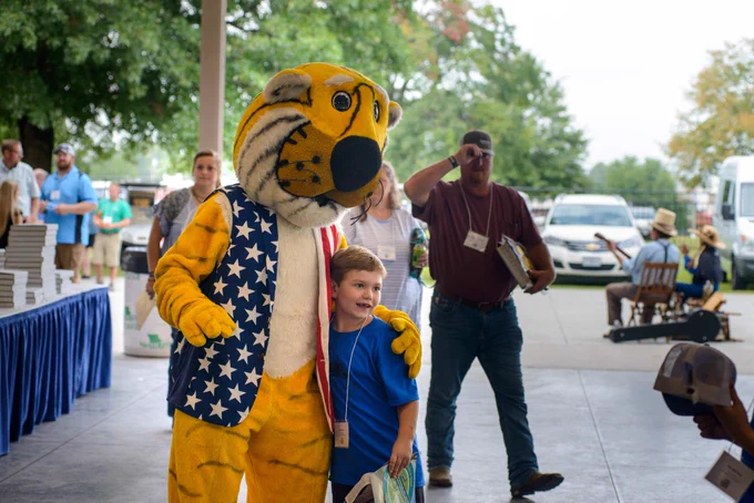 Truman the Tiger posing with a potenial future farmer at Farm Family Day at the Missouri State Fair. 