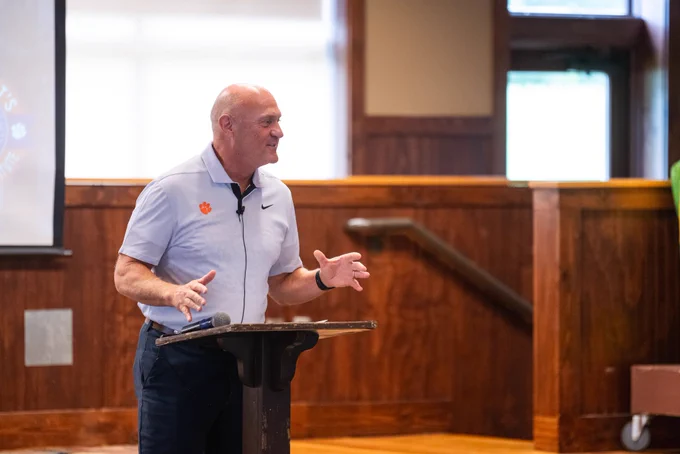 President Clements standing at a podium and speaking.