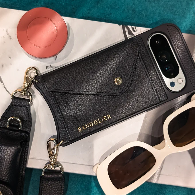 Wintergreen Pixel 9 in a Bandolier phone case next to a pair of sunglasses.