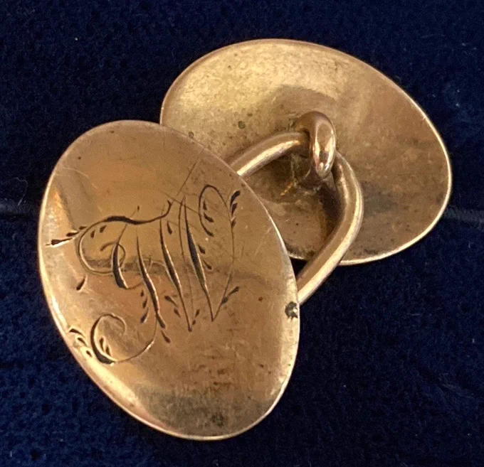 A photograph of Cufflinks engraved with JW. 