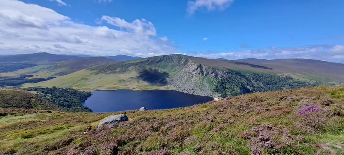 The Wicklow Mountains offer some of the most beautiful views in Ireland, especially on a sunny bank holiday. A popular viewing spot are the slopes overlooking Lough Tay. The lake lies between Djouce (725m) and Luggala (595m) mountains.