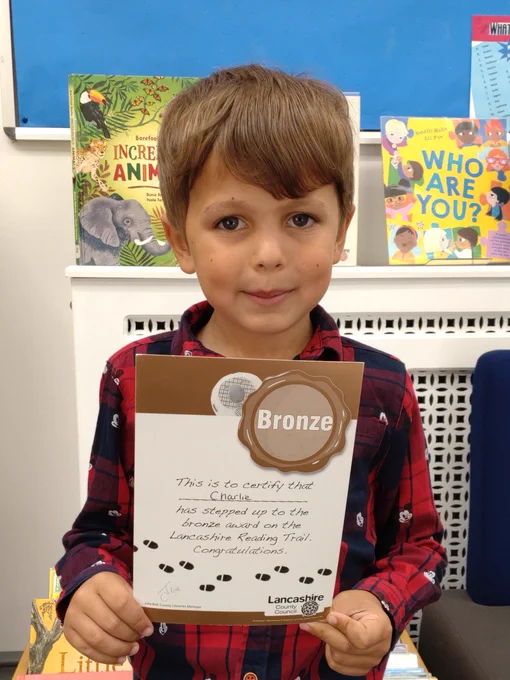 boy holding certificate