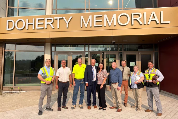 WPS officials stand in front of the new Doherty Memorial High School.