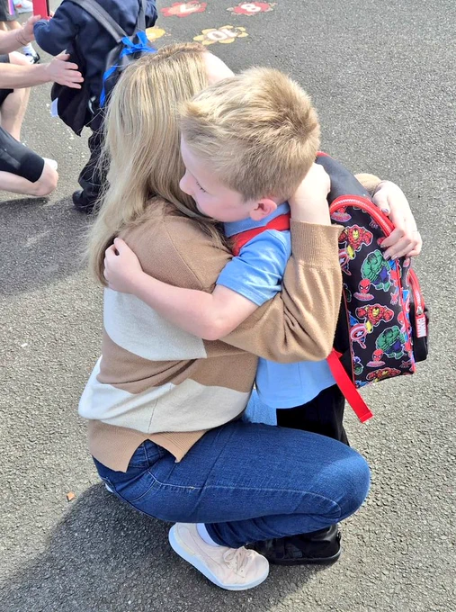 Mrs Ham cuddling littlest Ham after his first day as a Primary 1