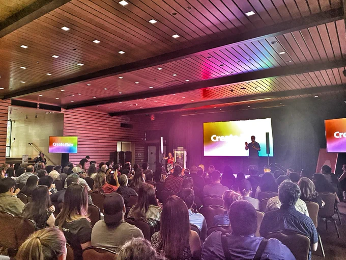 Crowd shot of the Adobe Create Now San Antonio event. Picture taken from the back right corner, facing the stage and speaker