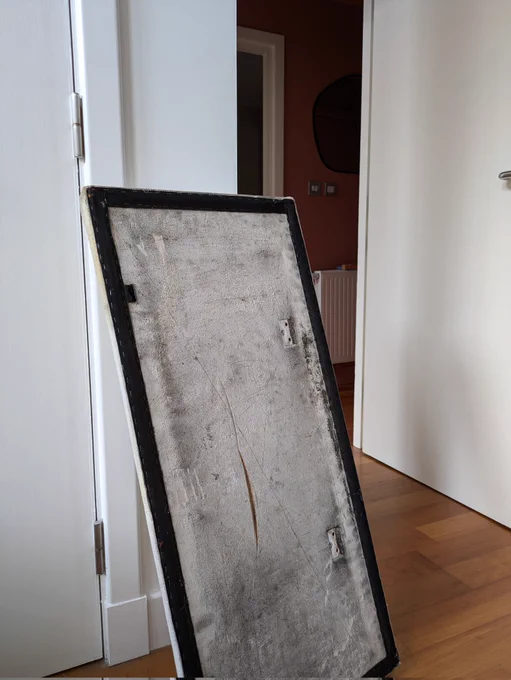 A white base from a Glasgow subway seat. There is black mould 