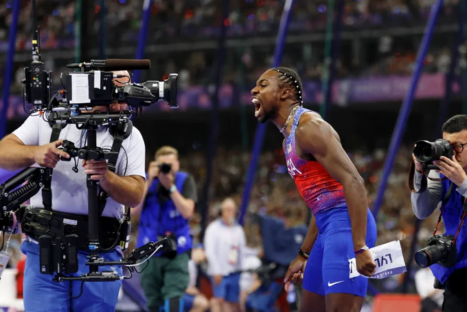 Noah Lyles looking into a camera after the men's 100m at the Paris Olympics.