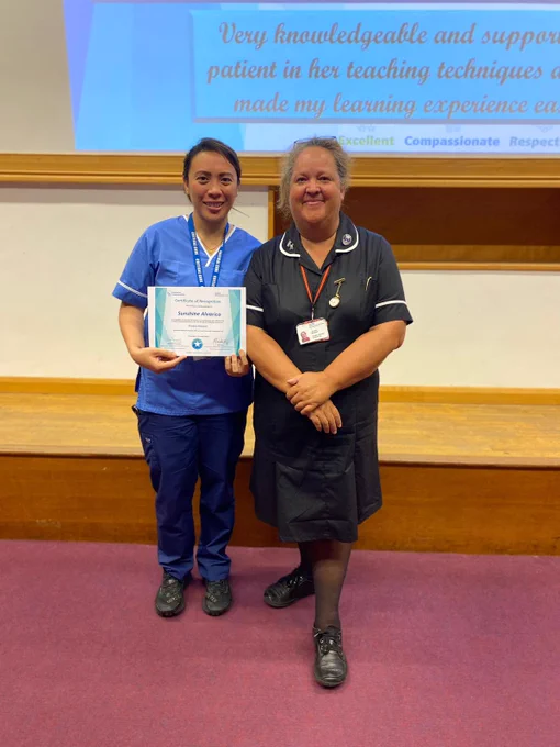 Staff nurse Sunshine receiving an award at Southend hospital