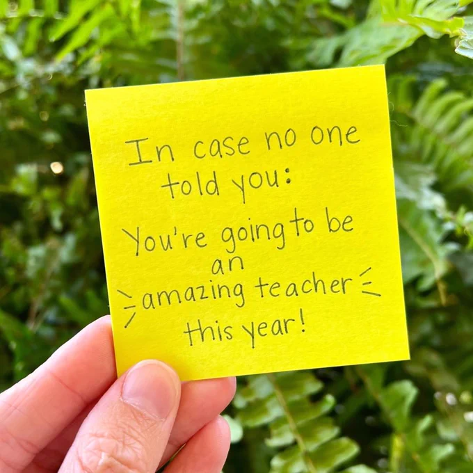 Hand holding a yellow sticky note with writing on it: "In case no one told you: You're going to be an amazing teacher this year!"
