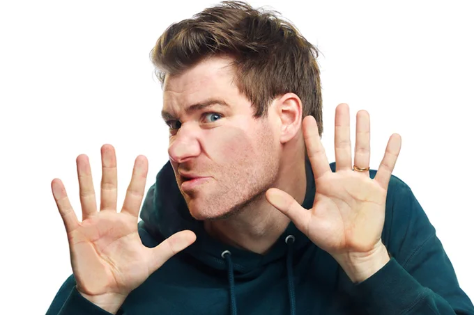A photo showing a man pressed against a transparent surface, with a white background 